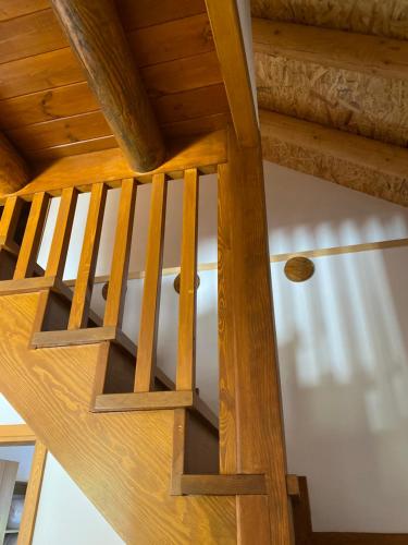 a wooden staircase in a house with wooden ceilings at Vila Ramaj in Berat
