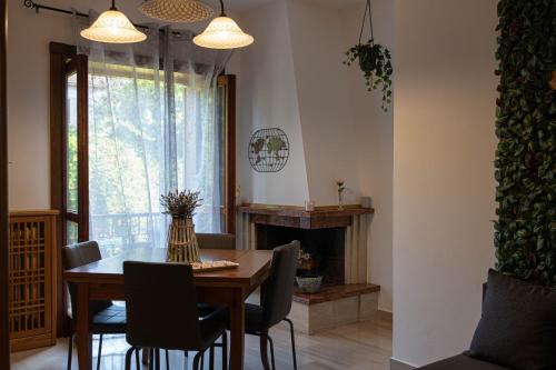 a dining room with a table and chairs and a fireplace at Angelì casa vacanza in Mercato San Severino