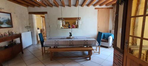 a dining room with a table and a chair at DEMEURE DU VIVIER in Appenai-sous-Bellême