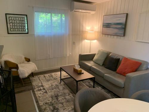 a living room with a couch and a table at Muskoka Waterfront Retreat in Dwight