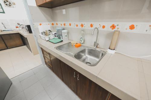 a kitchen with a sink and a counter top at PD Corner Lot 5R3BR 15pax Pool Homestay 5min to Beach in Port Dickson