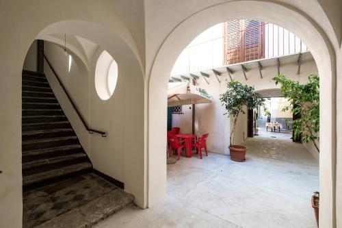 a hallway of a building with stairs and a table at B&B del Massimo in Palermo