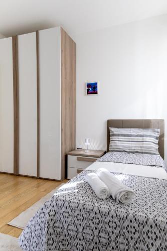 a bedroom with a bed with two towels on it at Ca'Rosa Venezia in Venice