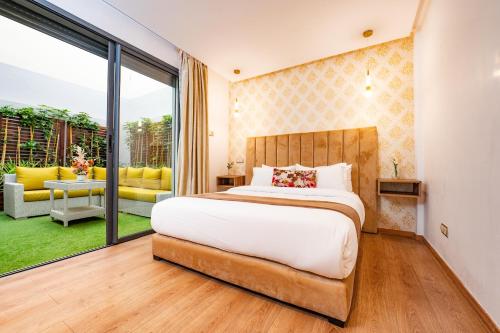 a bedroom with a bed and a large window at Family Aparthotel in Casablanca