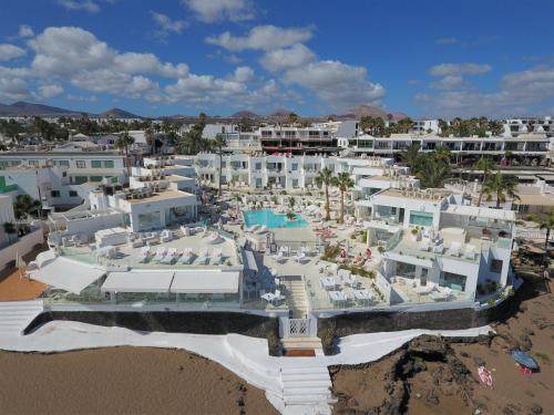 an aerial view of the hotel and the beach at Lani's Suites de Luxe - Adults Only in Puerto del Carmen