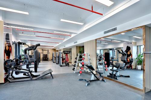 a gym with treadmills and cardio equipment in a room at 银都酒店 Yandoo Hotel in Yiwu