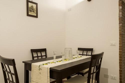 a black table with chairs and a white table cloth at B&B del Massimo in Palermo