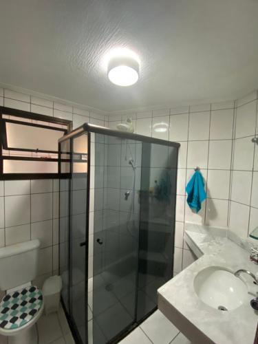 a bathroom with a shower and a sink and a toilet at APARTAMENTO EM BERTIOGA in Bertioga