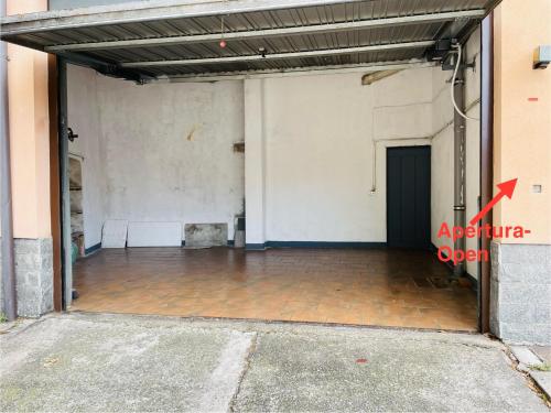 an empty room in a building with an open door at GreatLakeMountainView in Vercurago