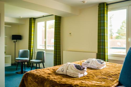 Postel nebo postele na pokoji v ubytování Hôtel-Restaurant Bel Ami