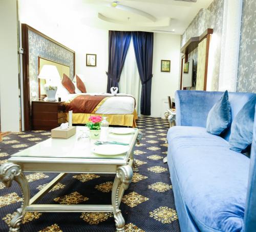 a hotel room with a couch and a bed at Rest Night Serviced Apartments- AlHamra in Riyadh
