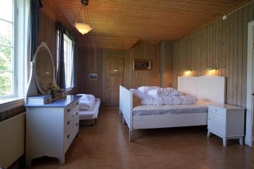 a bedroom with a bed and a dresser in it at Flørli 4444 Hostel in Fløyrli