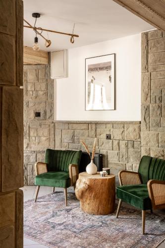 a living room with two green chairs and a coffee table at Dom Górski 878 mnpm in Zakopane
