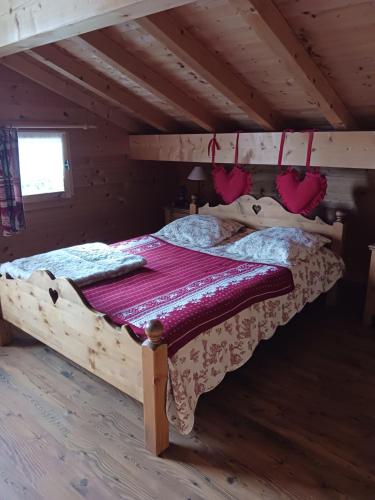 a bedroom with a bed in a attic at crostet du poele in Hauteluce
