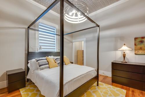 a bedroom with a four poster bed with white sheets at Cozy and Modern Norcross Hideaway with Covered Porches in Norcross