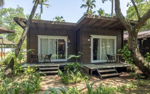 a house on the beach with a porch at Montego Bay Beach Village - Morjim in Morjim