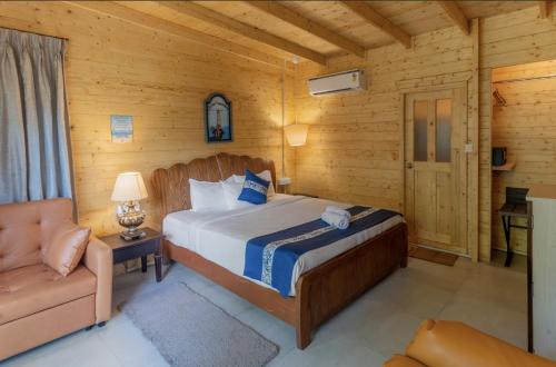 a bedroom with a bed and a couch in a room at Montego Bay Beach Village - Morjim in Morjim