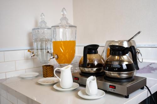 a kitchen counter with a blender and a pitcher of orange juice at A&A Toronto Hotel in Ho Chi Minh City