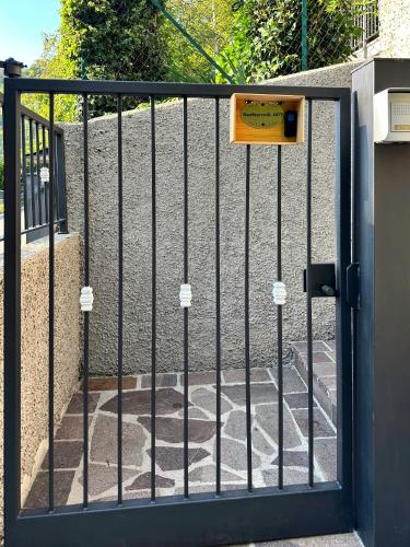 a metal gate with a sign on it at VIASANMARCO12.APT in Torre deʼ Busi