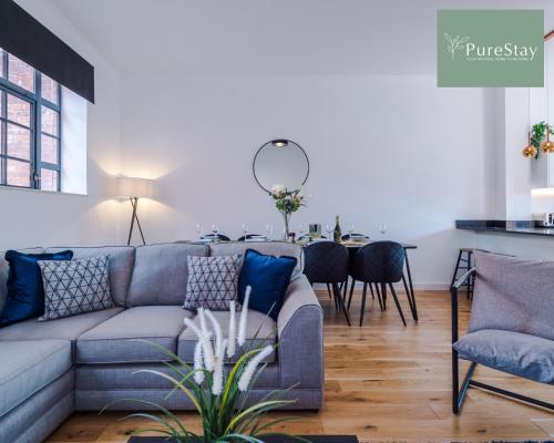 a living room with a couch and a table at Stunning Central House By PureStay Short Lets & Serviced Accommodation Birmingham in Birmingham
