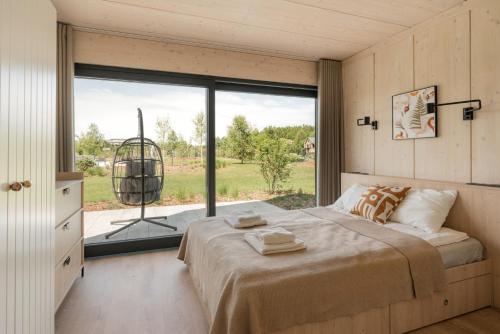 a bedroom with a bed and a large window at Siema Siemiany in Siemiany