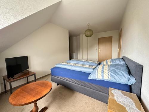 Dormitorio pequeño con cama y mesa en Mitten in Detmold mit schönem Ausblick, en Detmold
