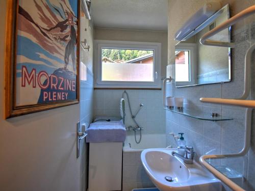 une salle de bain avec un lavabo et un miroir dans l'établissement Appartement cosy 2 pièces proche du centre, avec balcon et casier ski - FR-1-524-58, à Morzine