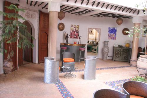 a living room with a table and chairs at VILLA CATHERINE MARRAKECH in Marrakech