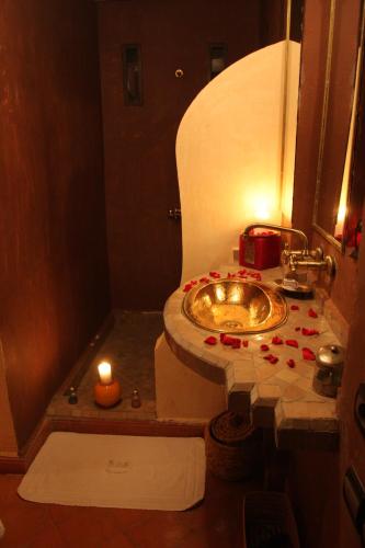 a bathroom with a sink with two candles on it at VILLA CATHERINE MARRAKECH in Marrakech