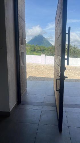 a door to a room with a view of a beach at Villa Venecia Colonial in Venecia