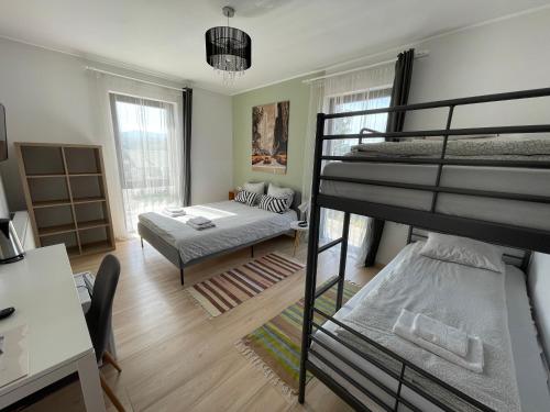 a bedroom with two bunk beds and a living room at ALPIN rooms in Topliţa
