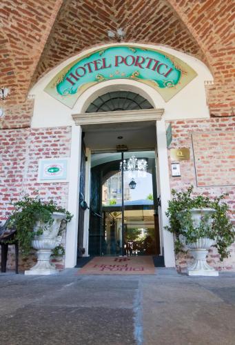 a building with a sign that reads hotel parking at Hotel Portici in Vicoforte