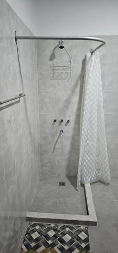 a shower with a shower curtain in a bathroom at Complejo Llay in La Rioja