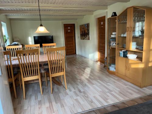 a kitchen and dining room with a table and chairs at Smedegaard værelser in Skjern