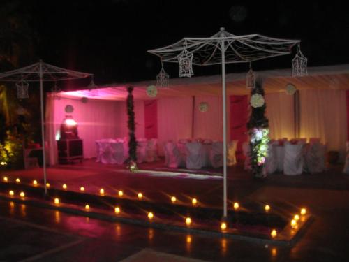 a pink room with a stage with lights in it at VILLA CATHERINE MARRAKECH in Marrakech