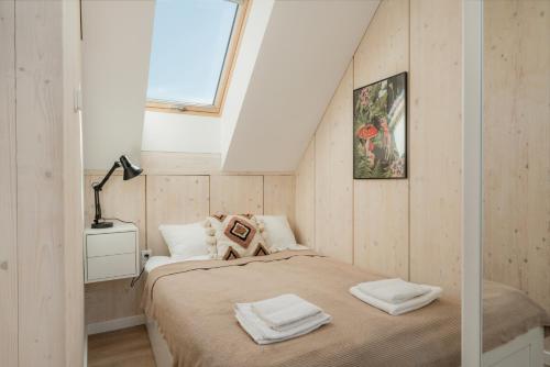 a small bedroom with a bed and a window at Siema Siemiany in Siemiany