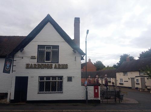 a white building with aumbledore arrows sign on it at The Hardinge Arms in Melbourne