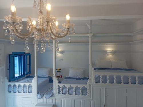 a bedroom with two bunk beds and a chandelier at Olympos Princess in Olympos