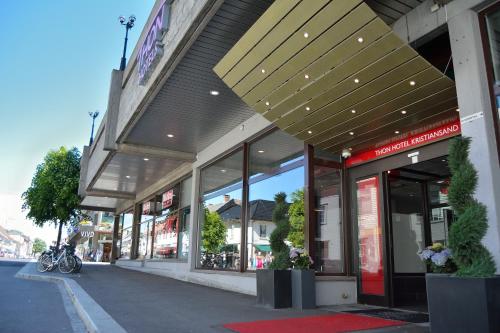a store front with awning on a city street at Thon Partner Hotel Kristiansand in Kristiansand