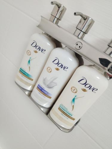 three bottles of dave moisturizers hanging from a bathroom sink at Holiday Inn Express Lompoc, an IHG Hotel in Lompoc