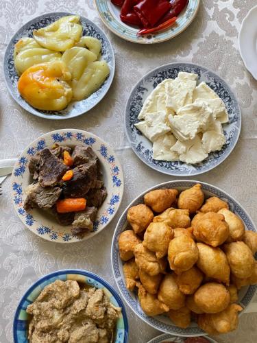 a table with four plates of food on it at Household Babovic - Old house Miljan's valley in Andrijevica