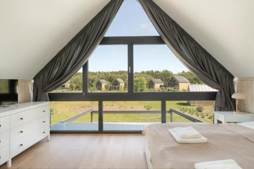 a bedroom with a large window with a large bed at Siema Siemiany in Siemiany