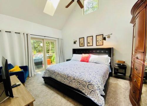a bedroom with a bed and a tv and a window at Ocean Mist Getaway(OMG) in Eastsound
