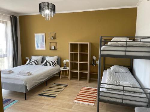 a bedroom with two bunk beds and a bed at ALPIN rooms in Topliţa