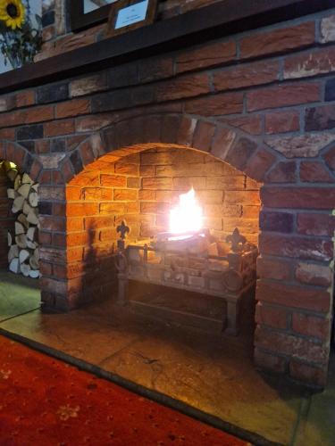 a brick oven with a fire in it at Primroses, Wood Farm in Shipdham