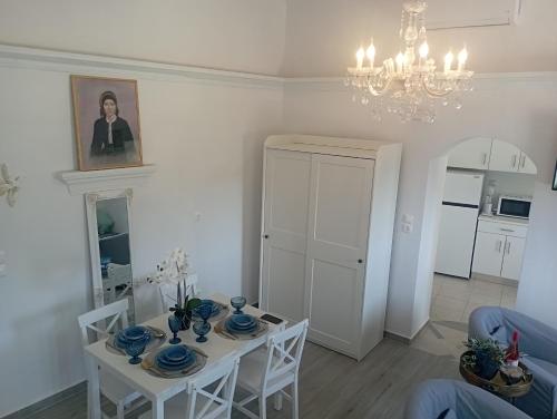a living room with a table and chairs and a chandelier at Olympos Princess in Olympos