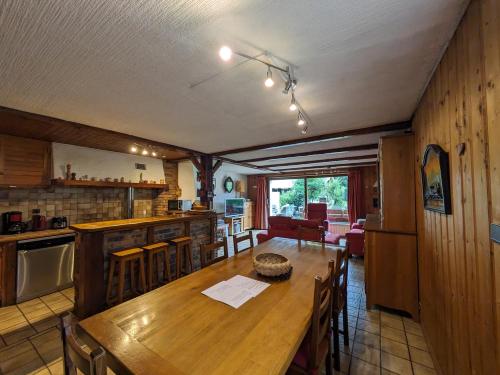 a kitchen and dining room with a wooden table at Belle Vue Des Praz in Chamonix-Mont-Blanc