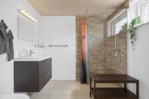 a bathroom with a shower and a sink at Kastanievejens overnatning in Svendborg