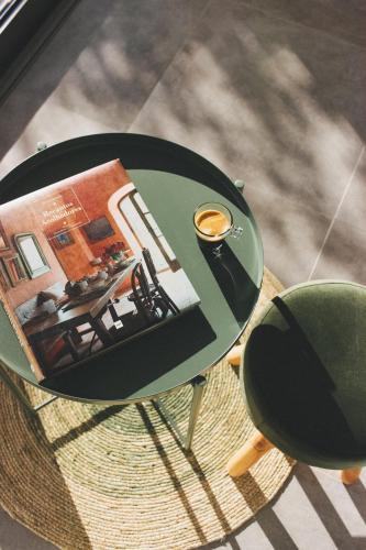 a glass table with a cup of coffee on top of it at Casa LNNoa Boutique Room whit private pool in Lagos