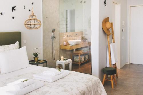 a bedroom with a bed and a bathroom with a sink at Casa LNNoa Boutique Room whit private pool in Lagos